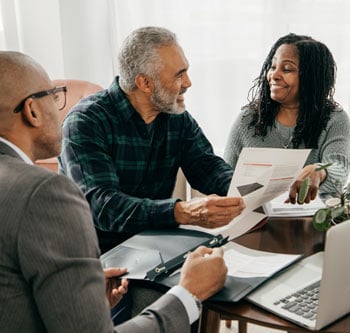 Three people discussing estate planning