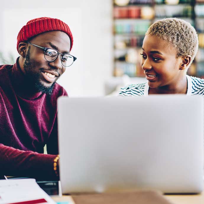 Two people working on laptop together