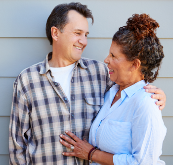 Man and woman holding each other and smiling