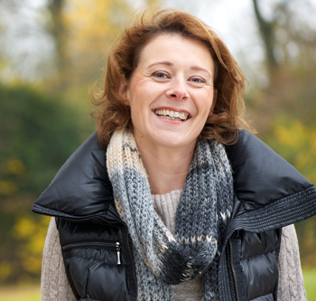 Woman smiling and wearing puffy vest